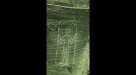 Long Man of Wilmington in East Sussex, UK gets a lick of paint by volunteers who help look after this ancient chalk figure carved into the Downs.