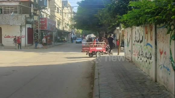 Palestinians parade through Gaza streets on Israeli military vehicle following rocket attacks