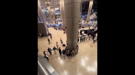 Travellers hold hands amidst panic at Tel Aviv airport