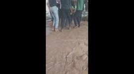 Dozens of people danced in the mud after heavy rain during the party