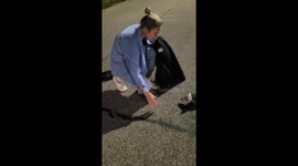 Two women rescue hedgehog stuck in middle of road with coffee cup on head