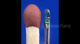 Artist's 0.8mm wide Mickey Mouse fits in the eye of a NEEDLE