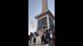 Pro Palestine protesters set of smoke flare and fire works in Trafalgar Square