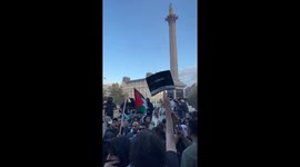 Pro Palestine protesters chant slogans  in Trafalgar Square