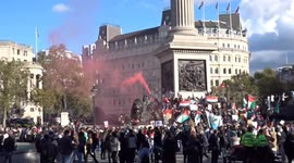 Pink smoke rises over Trafalgar Square during march in support of Palestine in London