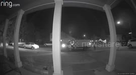 A delivery driver with Ontrac tosses packages with infant on hip.