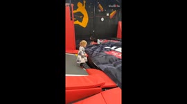 Little toddler trying to get on a puffy pad slips between them *Hilarious*