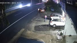Driver jumps into car to stop it from sliding down road in China