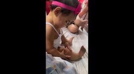 Toddler adorably fascinated by her chubby legs and tries to eat them
