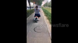 Riding Electric Bike with Crooked Rear Wheel in Shenyang, China