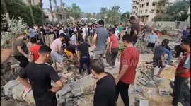 People search for survivors in the rubble of a building in Deir Al-Balah, Gaza
