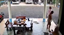 Father slips on wet floor and throws his shoes off his feet