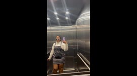 Woman's outfit flex in elevator comes to a spooky halt after lights go out