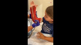 Young boy sits bravely while the medical professional take off his arm cast
