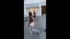 Pretty lady dances with a metal ring with fire