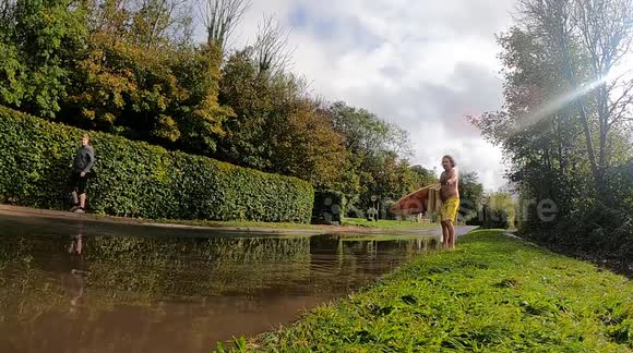 STATIC SURFING VILLAGE BARREL- USING A SHORT BOARD A LARGE VAN THROWS UP A WALL OF SURF