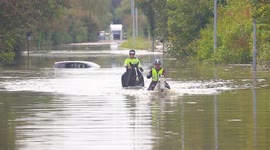 Women on horseback attempt to get through Storm Babet flooding in West Yorkshire