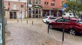 Floodwater rages down street in city of Caldas da Rainha, Portugal