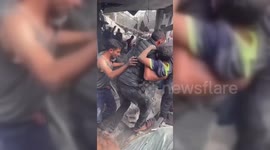 Gaza rescuers dig through rubble with bare hands to save young boy trapped in building collapse