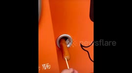 Chinese woman amused as sausage machine unexpectedly 'takes a bite' before dispensing