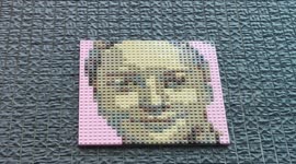 Mosaic of 12-year-old girl Lola, murdered by a woman,female killer, Dhabia B.  It’s a building like any other on rue Manin, in the 19th arrondissement of Paris, France. And since recently, if we stop there, we see to the right of the facade a small mosaic