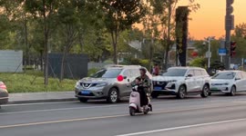 Child on scooter captures drifting balloon in perfect timing