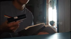 Student pranks university roommate with water pistol hidden under book