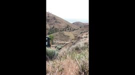 Construction Workers Demolish A Hilltop