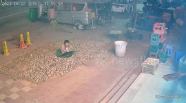 Chinese man distracted by phone steps into unsecured manhole