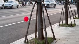 Delightful moment child on motorcycle catches floating balloon