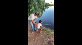Adorable boy has dad's full support on his first fishing adventure