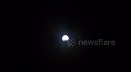 The Hunter Full Moon with partial Lunar eclipse seen briefly through the thick and heavy clouds and rain