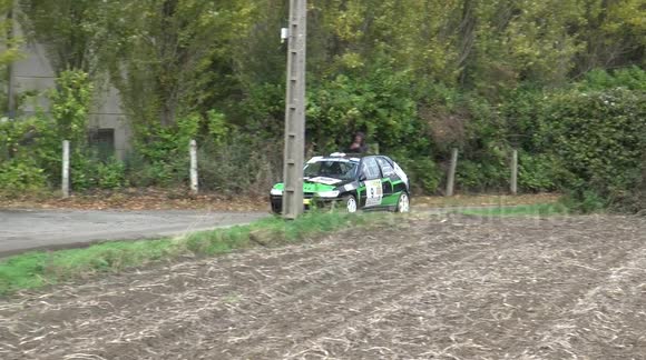 Look at the spectators! After the rally car leaves the track, they wonder why he is doing this...or not