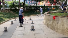 Elderly Chinese man astonishes onlookers with unique spinning top workout