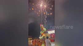 Terrifying moment a child dragon dancer crashes to the ground during stunt in Thailand