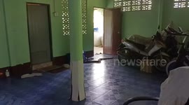 Locals use broom to usher huge python out of their front room