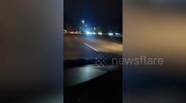 Python slithers on windscreen as car drives on Malaysian highway
