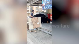 Neighbours jack up car to free dog stuck underneath