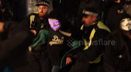 Met Police Public Order Officers forcefully detain a masked protestor at the Anonymous Million Mask March 2023