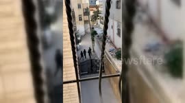 Israeli troops appear to fire in direction of girl filming them from a window in Shu'fat refugee camp in Jerusalem