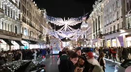 People look at this year's Christmas lights in Regents Street the light switch on had apparently been delayed twice as originally the lights were meant to be switched on at 5 pm and then 6 pm but they eventually came on at 6:30 pm. Londoners packed the st