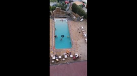 Man brings excitement to the table with an absurd dolphin dive into the pool