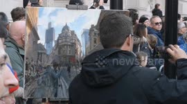 An artist who was painting the Lord Mayor's fair trips as he returns to his artwork