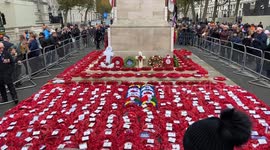 Red poppy wreaths surround The Cenotaph in Whitehall on Remembrance Sunday