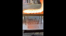 Dripping Molten Glass Over a Wooden Board With Holes