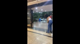 Hasty people get subdued by intense wind as they try to leave mall amidst a cyclone