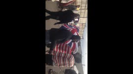 Migrants in Calais dancing with the British and American Flag