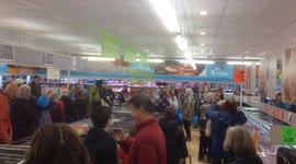 Flash mob suddenly start singing in UK supermarket