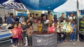 Voices of innocence: Displaced and injured Children Unite in Vigil at Al-Shifa Medical Hospital, Pleading for Ceasefire and an End to Israeli Attacks on Civilians.