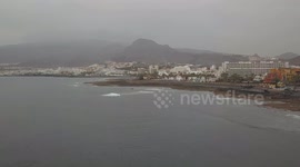 Drone video of the beach playa las america with surfers and the coastline